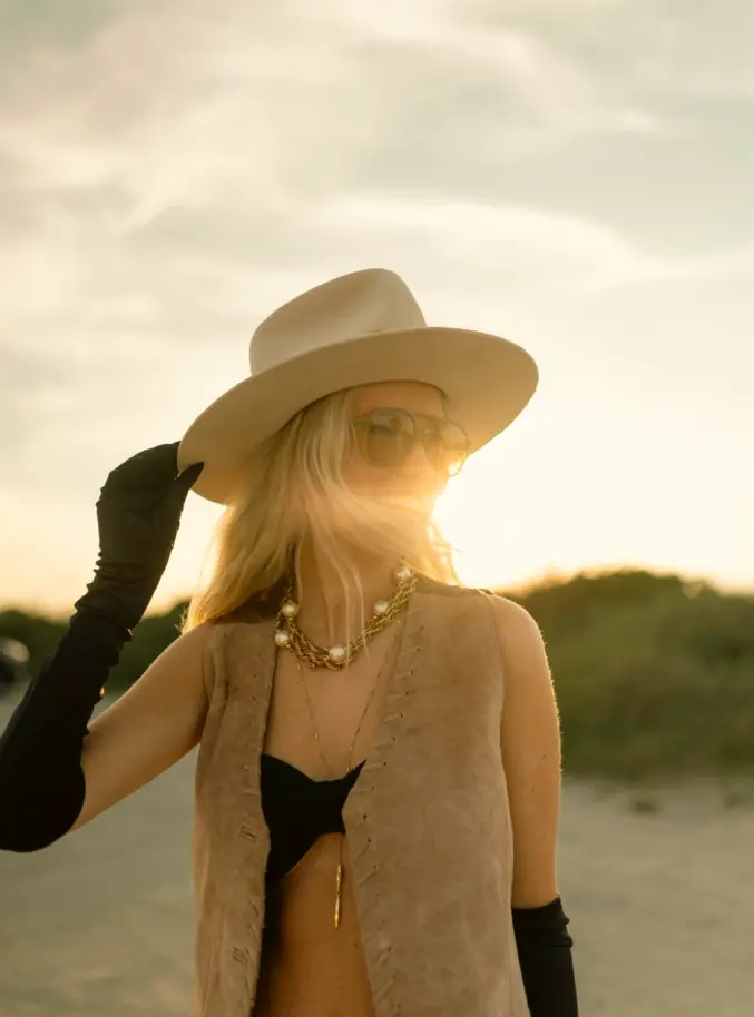 A wide-brimmed felt hat by Legend of Geraldine, worn at golden hour.